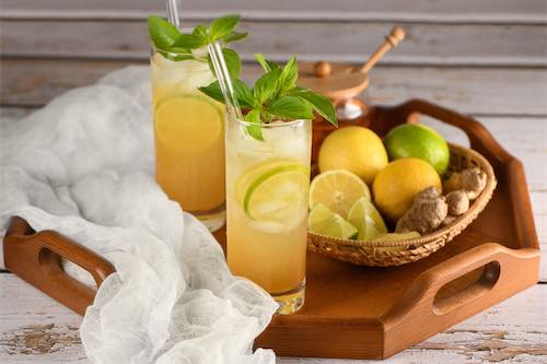 Lemon ginger vodka spritzer with lemon and ginger slices